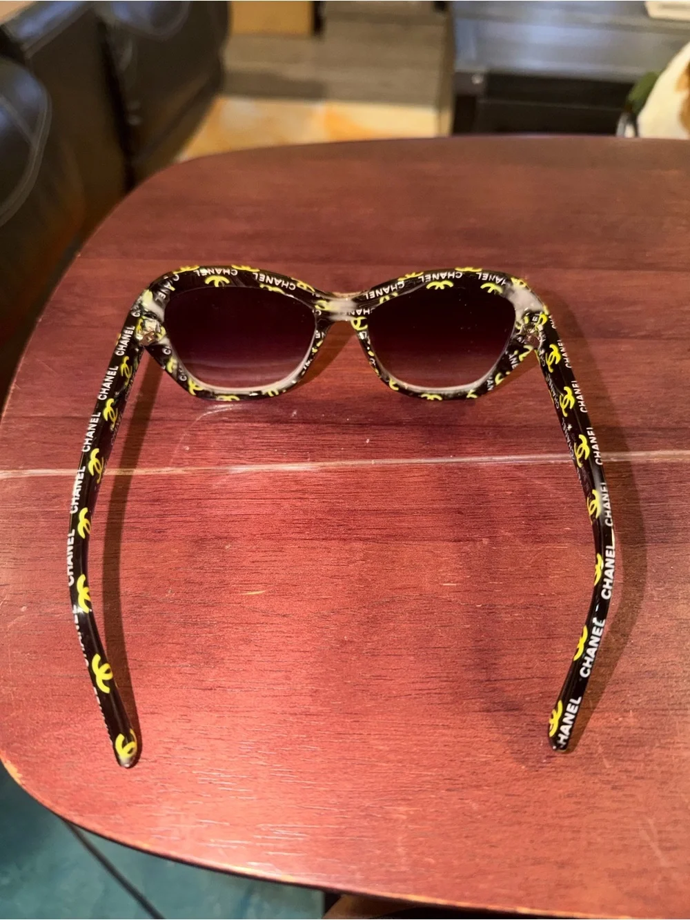 CHANEL Black Frame Sunglasses with Yellow Logo Accents